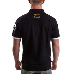 Maglia polo rugby vintage Nuova Zelanda nera con numero 3 bianco e scollo oro.