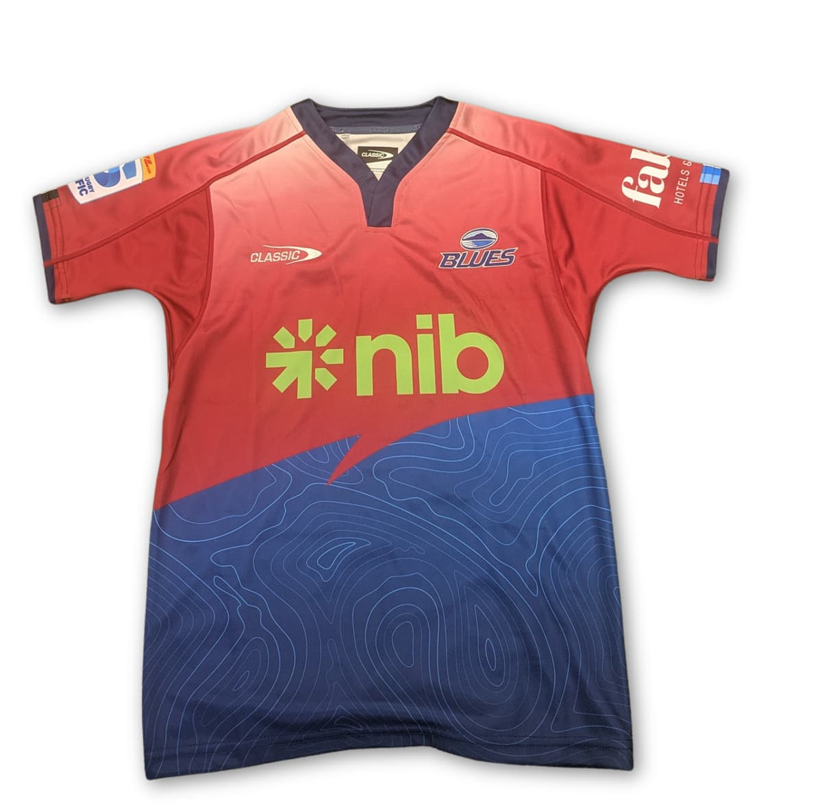 Maglia Rugby Blues Super Rugby Pacific Home TR2 2025 Ragazzo: Maglia da rugby Blues da ragazzo, design rosso e blu, per la stagione 2025 del Super Rugby Pacific.