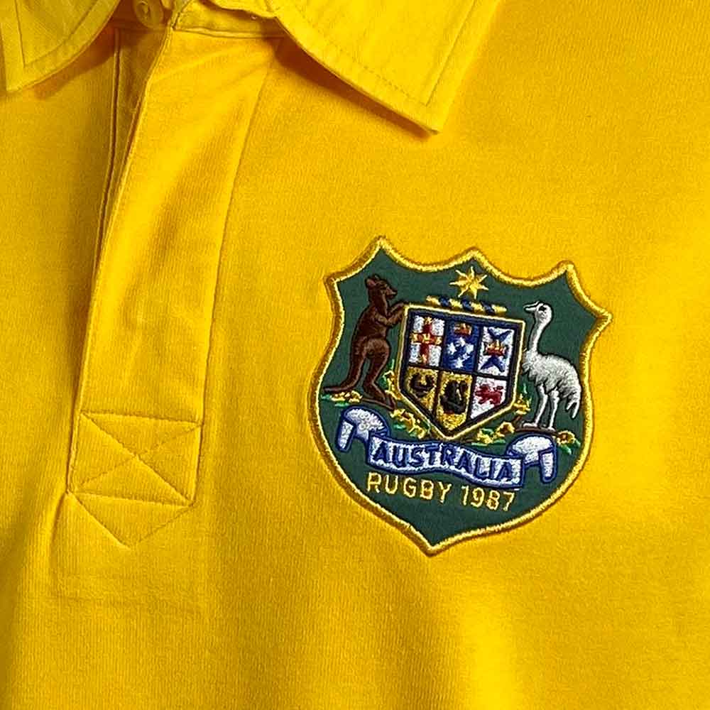Maglia da rugby vintage dell'Australia del 1987: maglia da rugby gialla con stemma australiano ricamato, ideale per collezionisti e appassionati di rugby.
