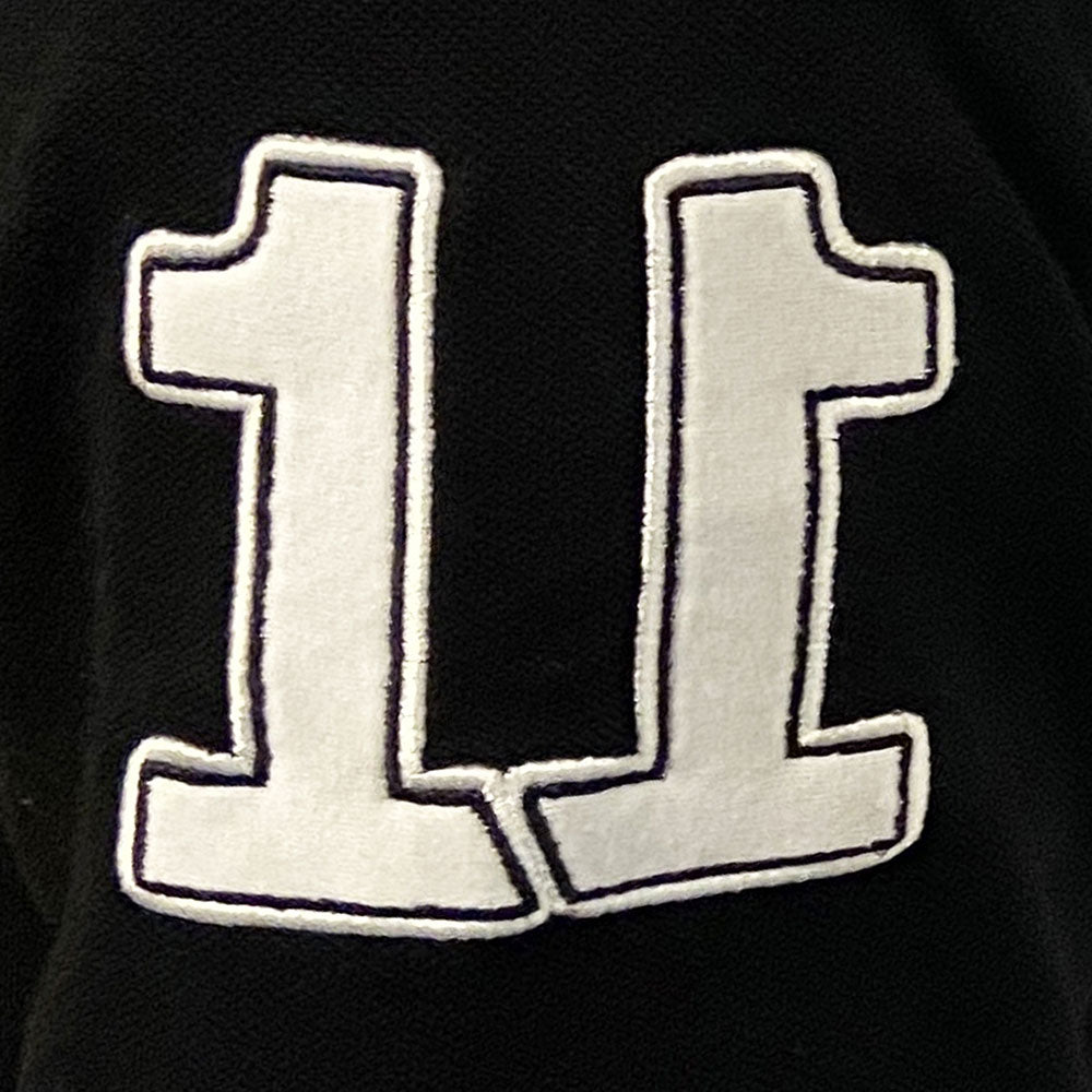 Maglia Rugby Vintage Ellis Rugby 1999 con numero 11 bianco su sfondo nero.