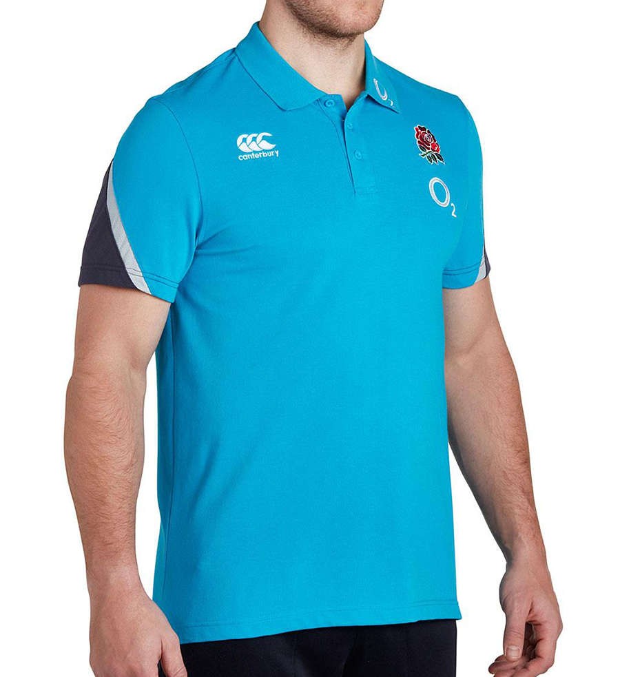 Polo da allenamento rugby Inghilterra blu Canterbury con stemma rosa.